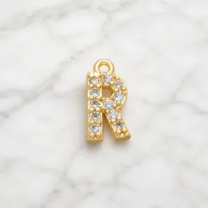Detailed view of an 18K gold-plated letter R pendant with cubic zirconia for DIY jewelry