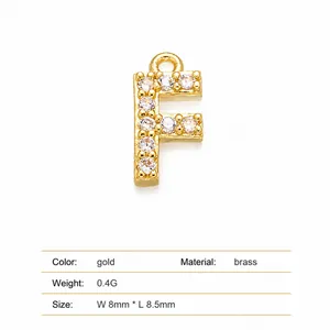 Detailed macro view of gold-plated brass letter F pendant with pave white zirconia