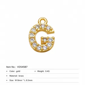 Detail of gold plated brass letter G charm with white cubic zirconia micro-inlay