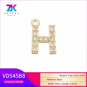Macro view of gold copper letter H pendant with cubic zirconia and 8mm size details