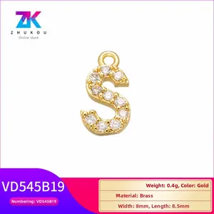 Detailed macro view of gold-plated brass letter S pendant with cubic zirconia stones