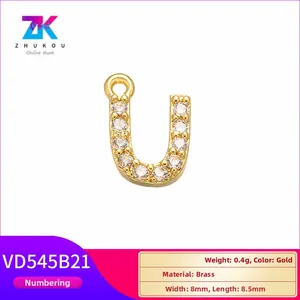 Macro detail of gold brass letter U pendant with cubic zirconia for jewelry DIY