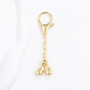 Detail of 18K gold plated balloon letter A pendant on a metal keychain with lobster clasp