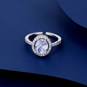 Detailed macro view of an oval halo zircon ring with an adjustable open silver band