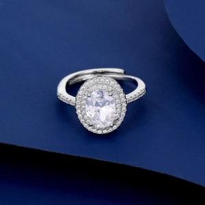 Detailed macro view of the oval-cut zircon center stone with double halo setting on silver ring