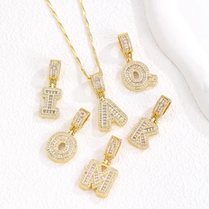 Golden iced-out 26 alphabet letter pendants with white zircon inlays and fine chain