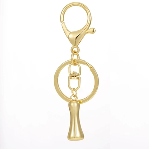 Close-up of 18K gold plated lobster clasp and swivel ring with a polished metal surface