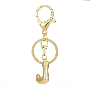 Macro view of polished 18K gold plated letter J keychain with lobster clasp and ring
