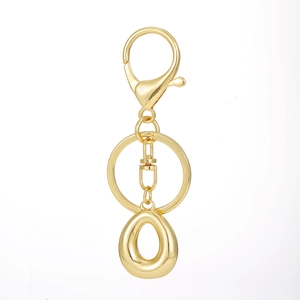 Detailed macro view of an 18K gold-plated alphabet keychain with a polished lobster clasp