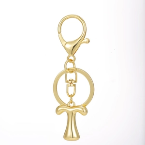 Close-up of polished 18K gold plated letter T alphabet keychain with lobster clasp