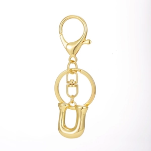 Close-up of a 18K gold-plated alphabet keychain with lobster clasp and U-shaped metal buckle