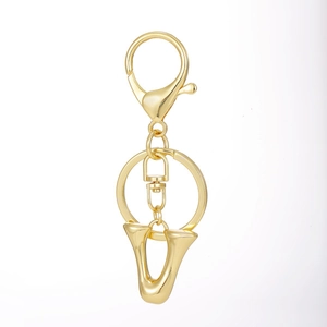 Detailed view of 18K gold-plated letter V pendant with lobster clasp and round key ring