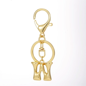 Detailed macro of 18K gold plated letter W keychain with heavy lobster clasp