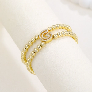 Double-layer 18k gold plated beaded bracelet with micro-paved crystal letter G charm