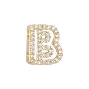 Macro shot of 18k gold plated letter B charm with micro-paved sparkling cubic zirconia