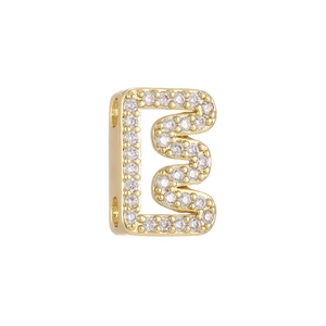 Macro shot of 18k gold plated bubble letter E bead with micro-pave cubic zirconia