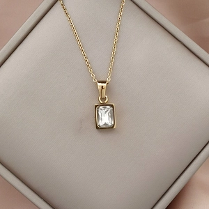 18K gold plated necklace with emerald cut clear zircon pendant on jewelry box