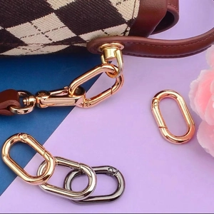 Macro view of oval metal spring buckles in gold silver and black on leather straps