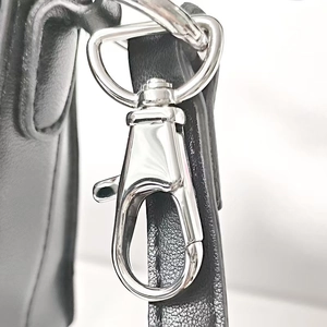 Polished 316 stainless steel swivel lobster clasp on a textured black leather bag strap