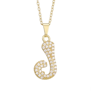 Close-up of golden letter J pendant with pave setting zircon stones on cross chain