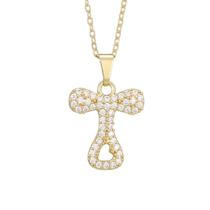 Macro shot of gold-plated letter T pendant with pavé cubic zirconia and heart cutout