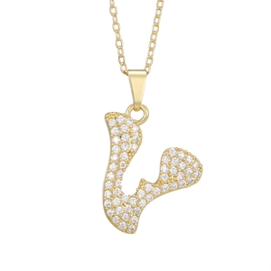 Detailed view of gold plated necklace with U-shaped pendant set with sparkling zircons
