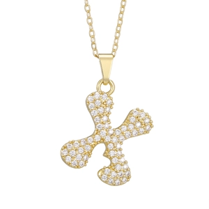 Macro shot of gold pendant with micro-paved zircons and fine gold chain detail