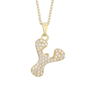Close-up of golden letter F heart pendant necklace with shimmering zircon pavé crystals