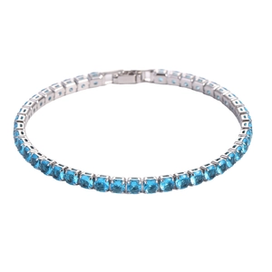 Detailed close-up of a silver tennis bracelet featuring blue square-cut zircons in 4-prong settings