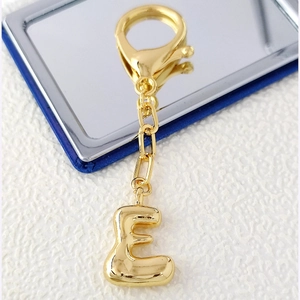 Polished 18K gold letter E keychain pendant with high-gloss mirror finish and lobster clasp