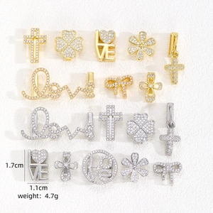 Detail of copper charms with cubic zirconia in cross and clover shapes for DIY bracelets