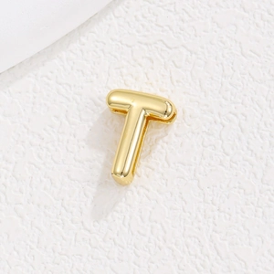 Détail macro du pendentif lettre T en 3D avec finition dorée polie et éclat métallique
