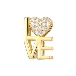 Macro shot of gold-plated LOVE charm with heart shaped clear cubic zirconia inlay
