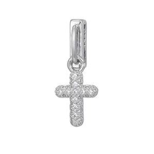 Close-up of silver cross pendant with pavé-set clear zircons and rectangular clasp
