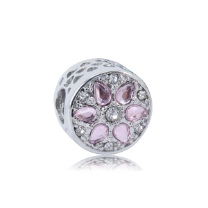 Macro detail of cylinder charm with hollow hearts and pink pear-shaped cubic zirconia petals