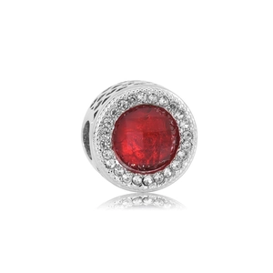 Detail of red faceted crystal charm bead with white zircon halo and hollow silver patterns