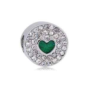 Detail of silver bead with green heart crystal and white cubic zirconia accents