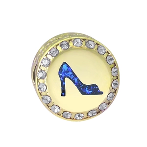 Close-up of heart charm with blue glitter high heel and sparkling white crystals