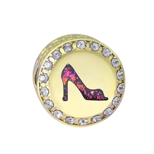 Close-up of golden charm bead with purple high heel pattern and sparkling crystals