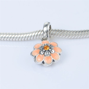 Macro shot of S925 silver flower charm with orange enamel and zircon on snake chain