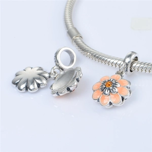 Detail shot of S925 sterling silver daisy charm with orange enamel and S925 hallmark