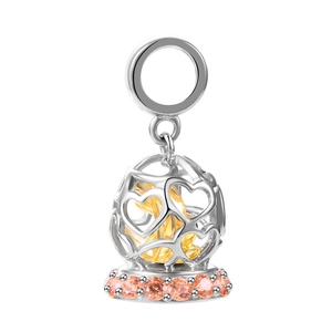Macro shot of S925 silver hollow heart charm with gold core and pink zircon stones