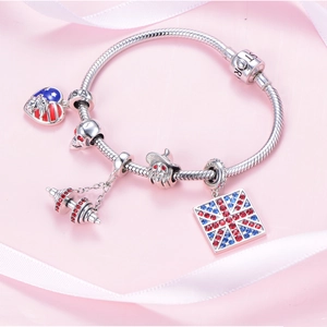 S925 sterling silver snake chain bracelet featuring skull and flag charms on pink background