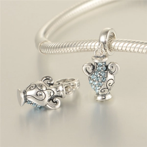 Macro detail of S925 sterling silver amphora charm with blue zircon stones on a bracelet