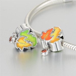 Macro detail of S925 sterling silver maple leaf charms with colorful enamel and orange gems
