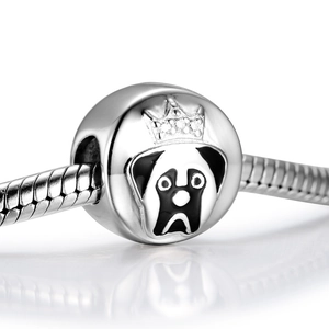 Macro detail of S925 silver pug dog charm with crown and zircon on snake chain
