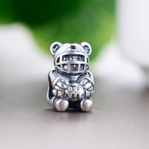 Macro shot of S925 sterling silver American football bear charm with vintage oxidized finish