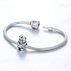 Detail of S925 sterling silver snake chain bracelet with rugby bear charm and LOVE engraving