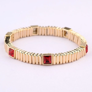 Golden stretch bracelet with vertical stripes and square red gemstone inlays