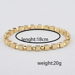 Elastic gold beaded bracelet with textured square cubes and polished metallic beads 18cm long